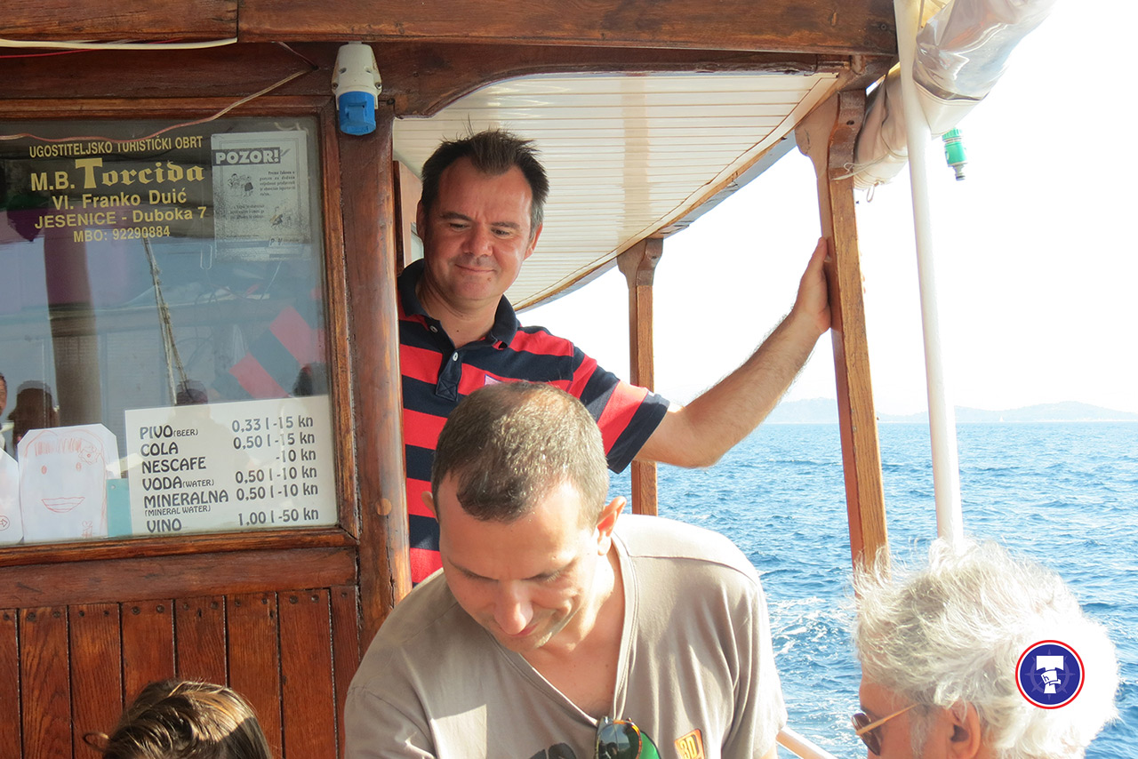 Captain Franko Duić steering MB Torcida during a private boat tour in Murter